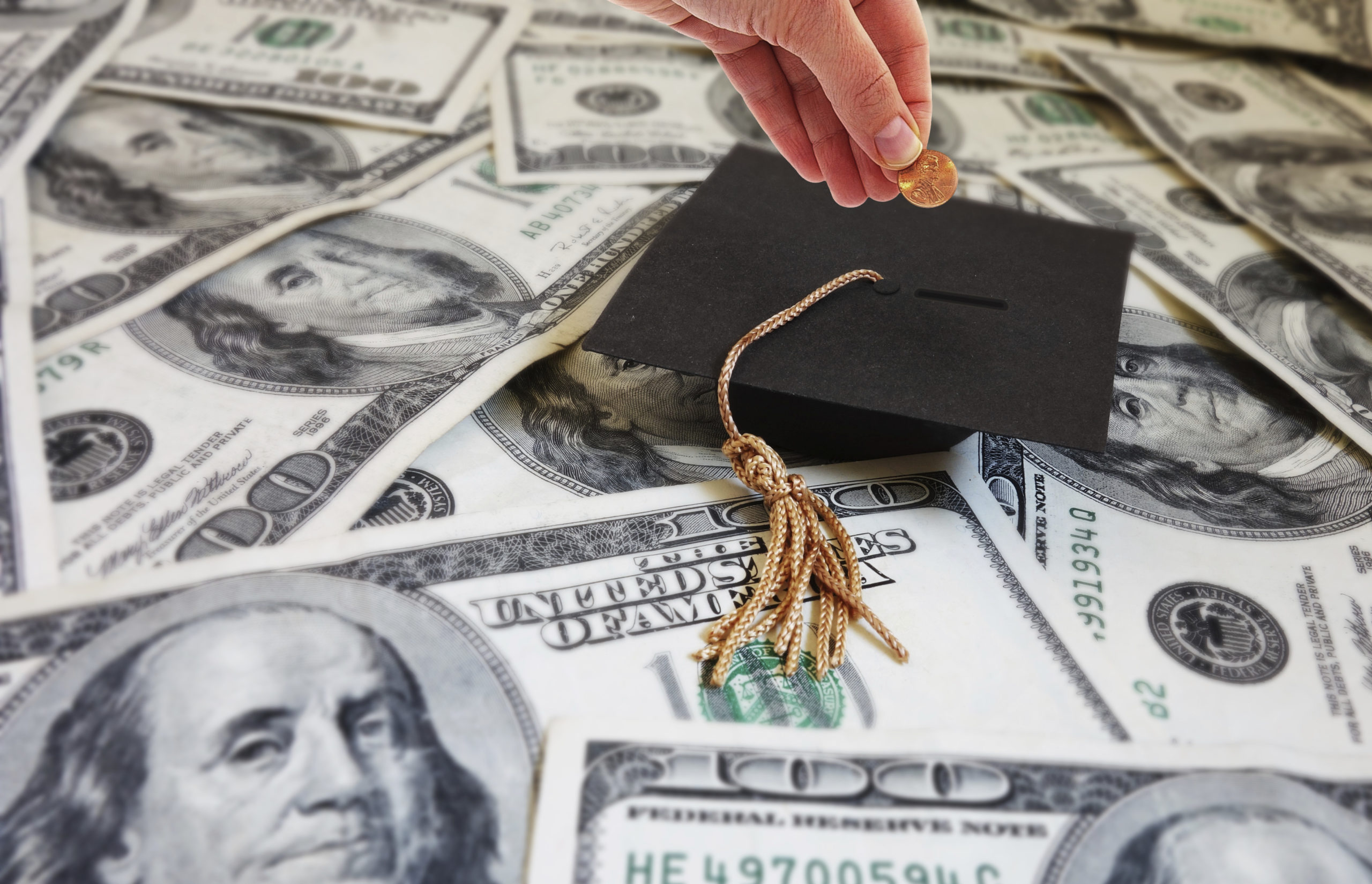 Graduation cap on dollar bills